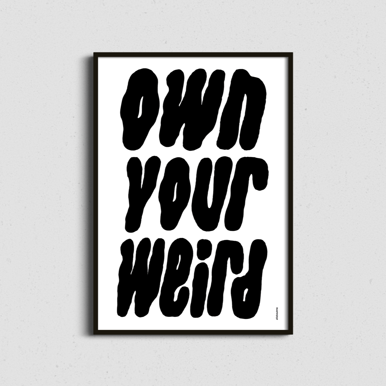 Monochrome framed art with “Own Your Weird” slogan – minimalist yet bold for modern interiors.