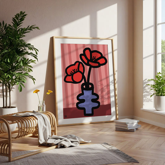 Framed Vibrant Poppy birth flower print for August birthdays. Features a heartfelt poem celebrating remembrance, passion, and creativity.art print of red flowers in a blue vase in a bright room with plants and furniture.
