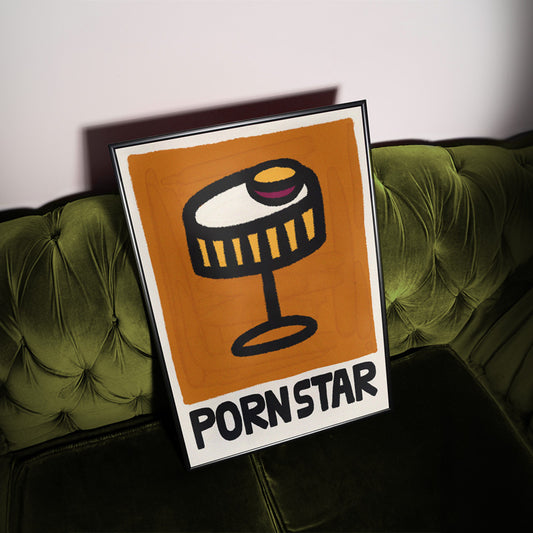 Framed poster with 'Pornstar' cocktail design on a green couch