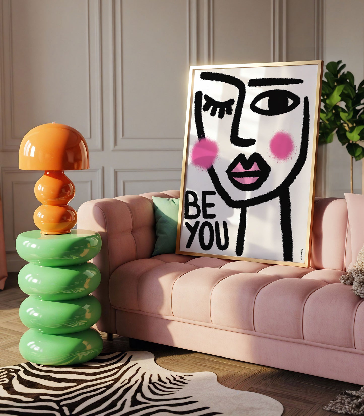 Modern living room with a pink sofa, colourful lamp, and a framed artwork with female illustration with 'BE YOU' text.