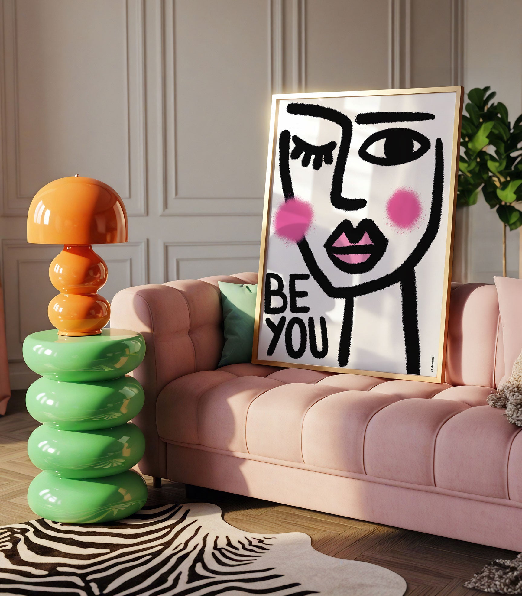 Modern living room with a pink sofa, colourful lamp, and a framed artwork with female illustration with 'BE YOU' text.
