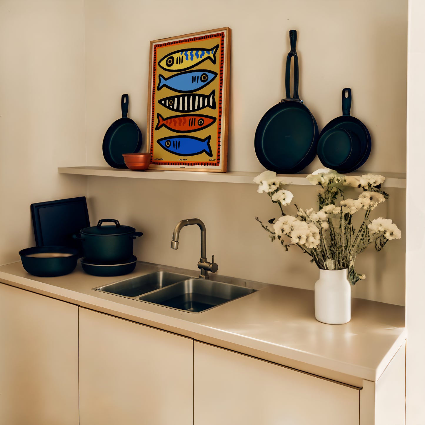 Hand-illustrated Sicily fish market print. Capture the charm and energy of Catania in your home with this travel-inspired art. Kitchen with pots, pans, and a decorative fish poster above a sink.