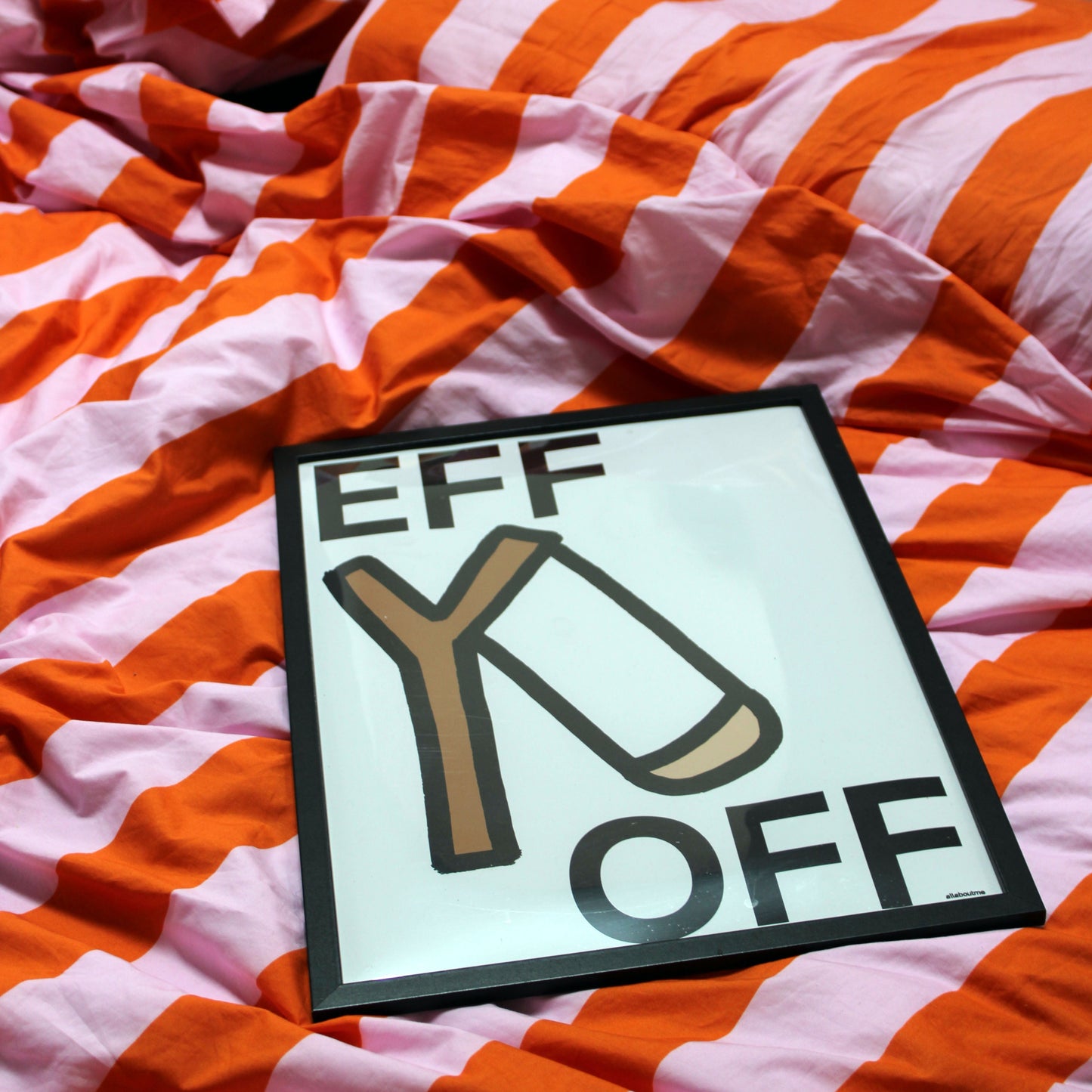 Sign with 'EFF Y OFF' text on a background of orange and white striped fabric