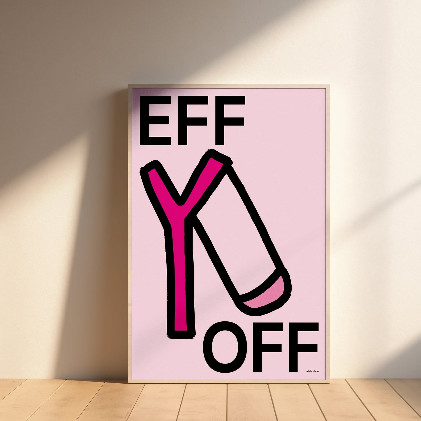 Framed artwork with 'EFF Y OFF' text on a pink background, leaning against a wall.