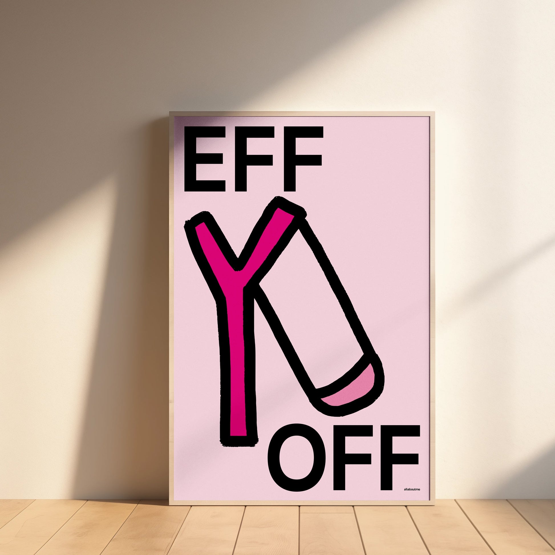Framed artwork with 'EFF Y OFF' text on a pink background, leaning against a wall.