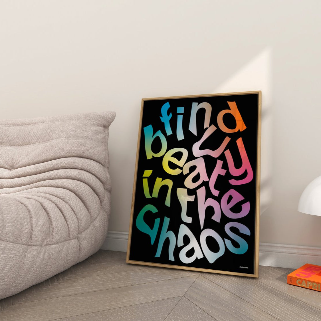 Colorful framed poster with motivational quote in a modern living room.