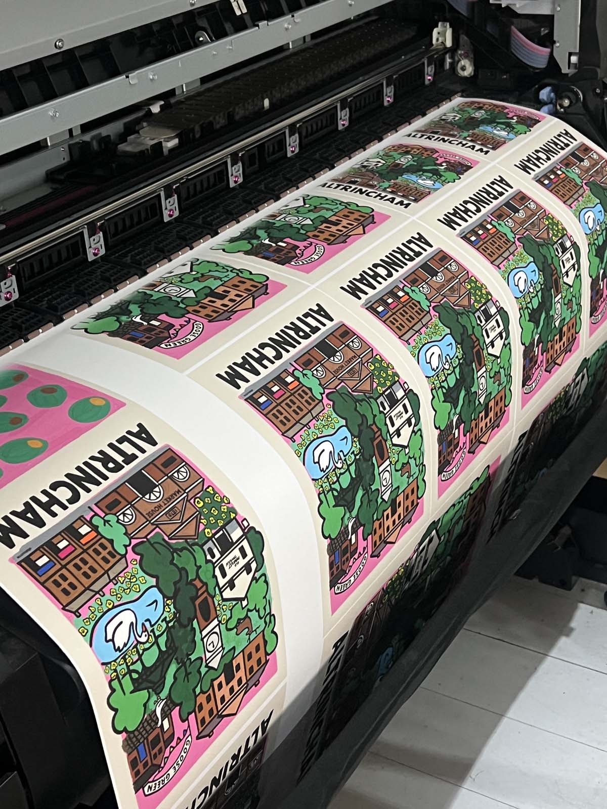 Printing process of colorful labels with 'Altricham' location on a large printer in my studio.