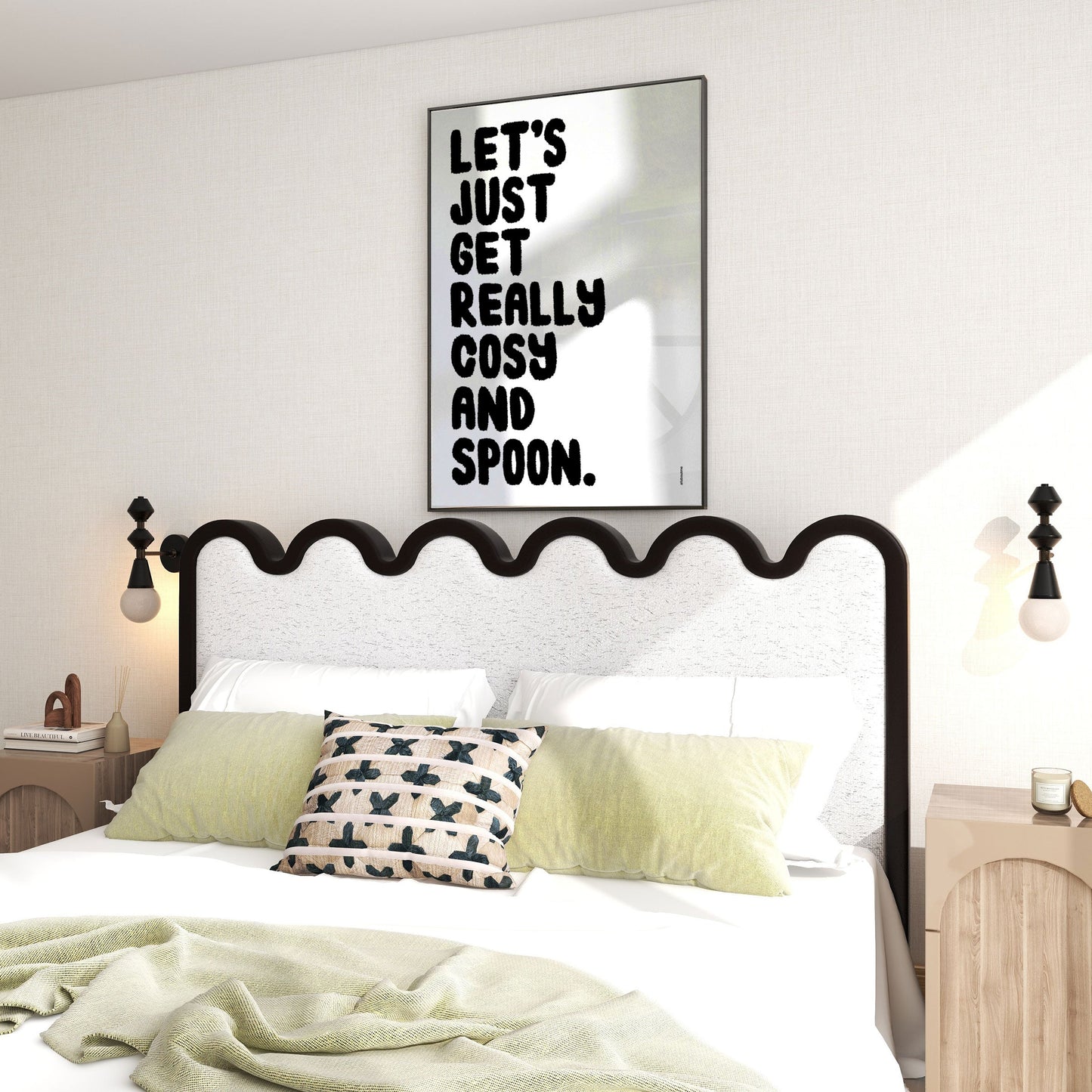 Bedroom with a black metal bed frame, white bedding, and a framed quote above the bed.