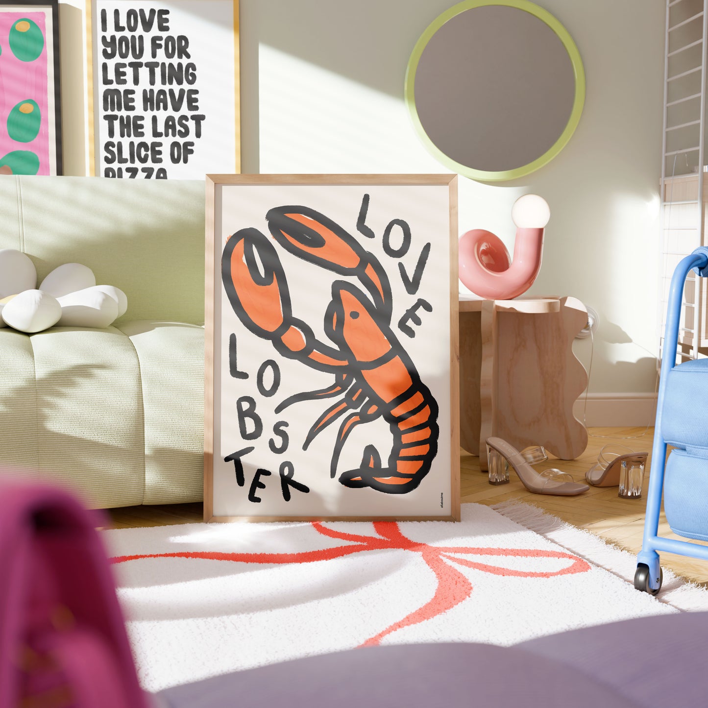 Framed artwork of a lobster with 'LOVE LOBSTER' text in a room with colorful decor.