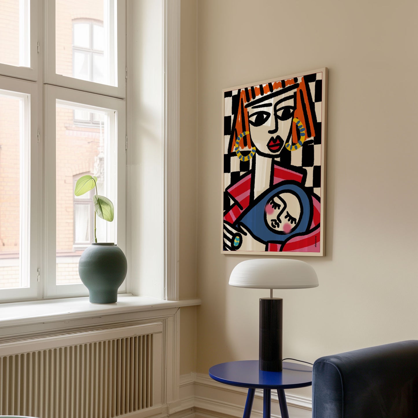  Empowered mum with bold orange hair holding baby, checkerboard backdrop, framed in white in living room – celebrating motherhood with style.