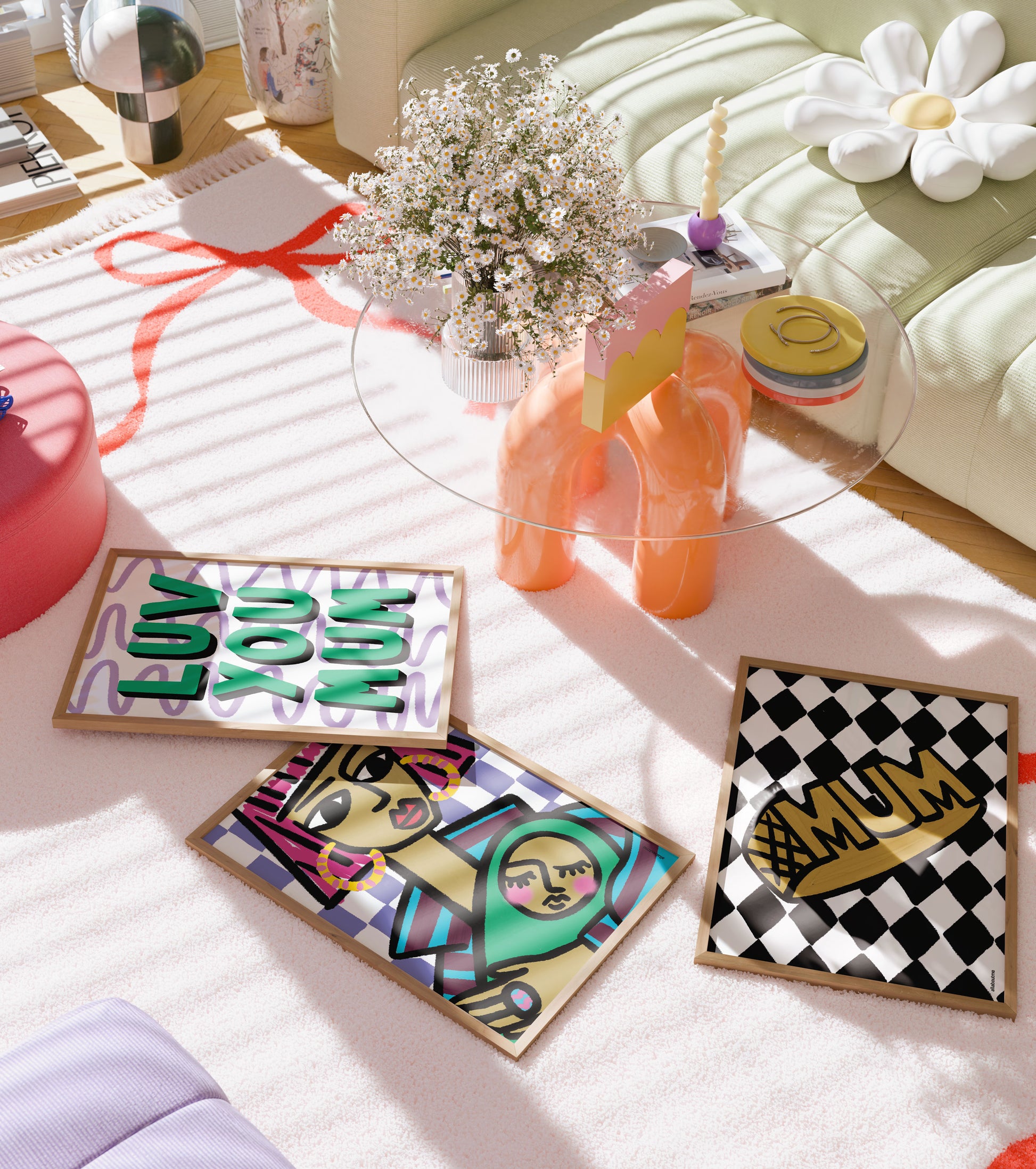  Bright green “Luv You Mum” art print with playful design, framed in black – a celebration of modern motherhood. several motherhood print designs on a table with a floral arrangement.