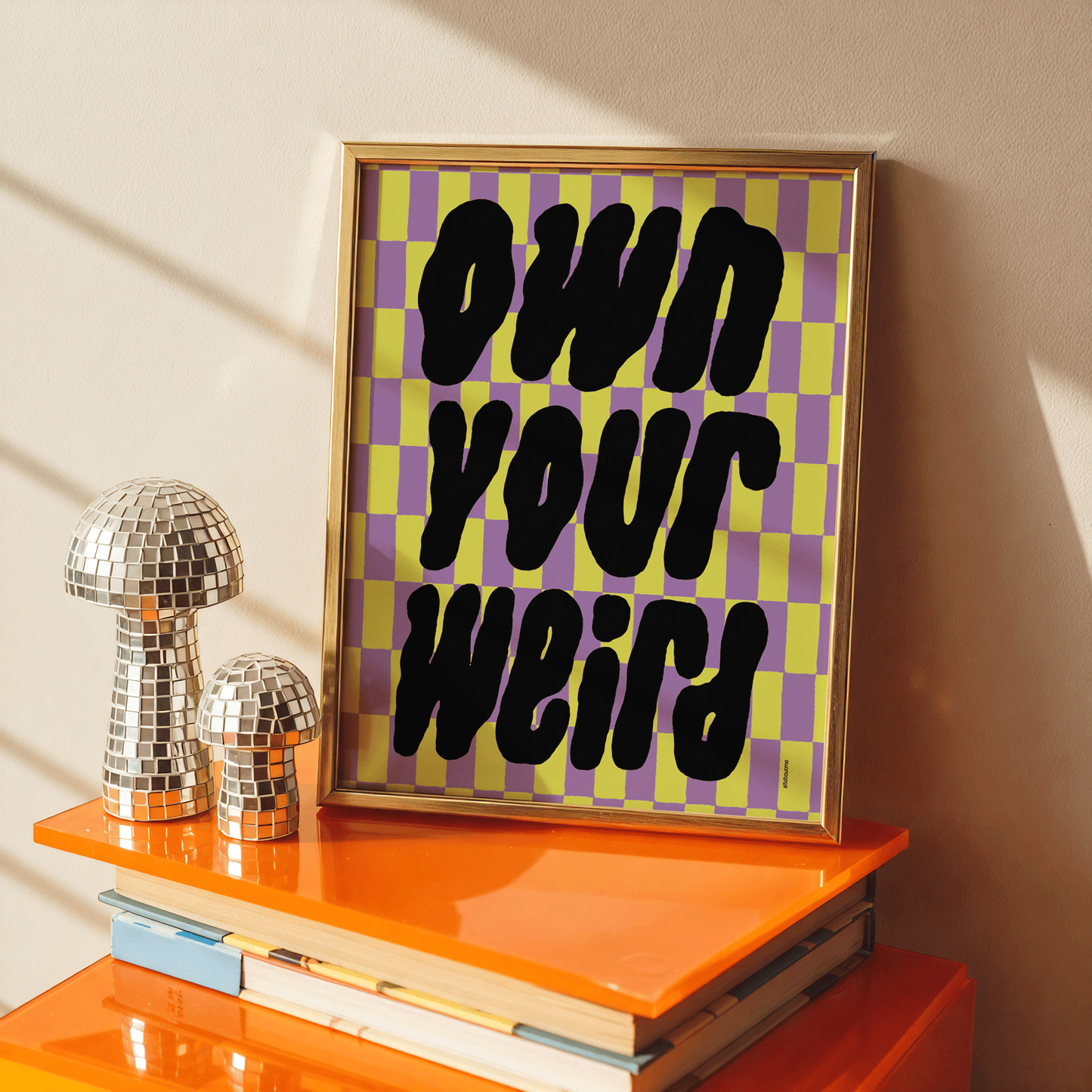  Framed checkerboard art print with bold “Own Your Weird” message – graphic, empowering and stylish.