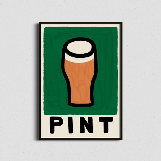 A framed art print featuring a stylized pint glass with a green background and the word 'PINT' below, displayed against a light gray textured wall.