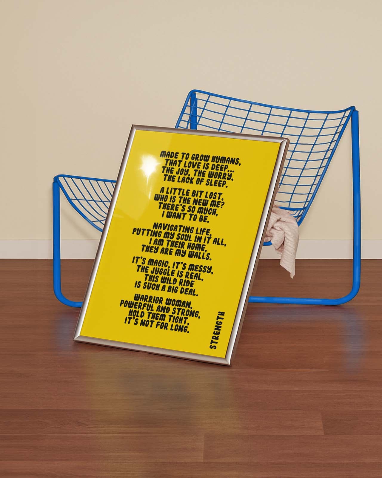 Yellow poster with text on a wooden surface with a blue metal frame in the background.