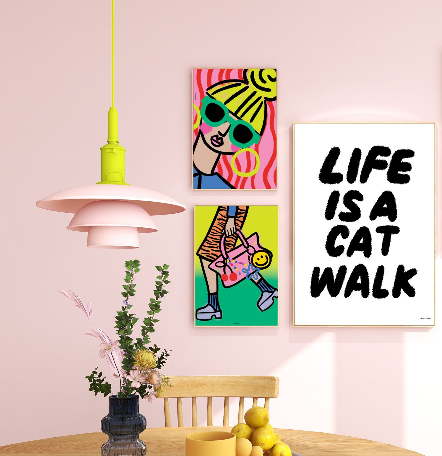 Colorful wall art and modern pendant light in a room with pink walls.