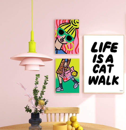 Colorful wall art and modern pendant light in a room with pink walls.