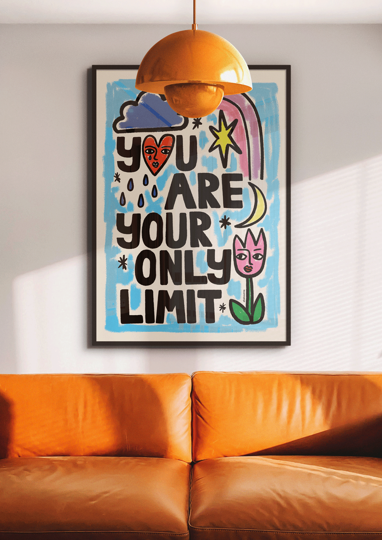 Colorful poster with motivational quote above an orange sofa