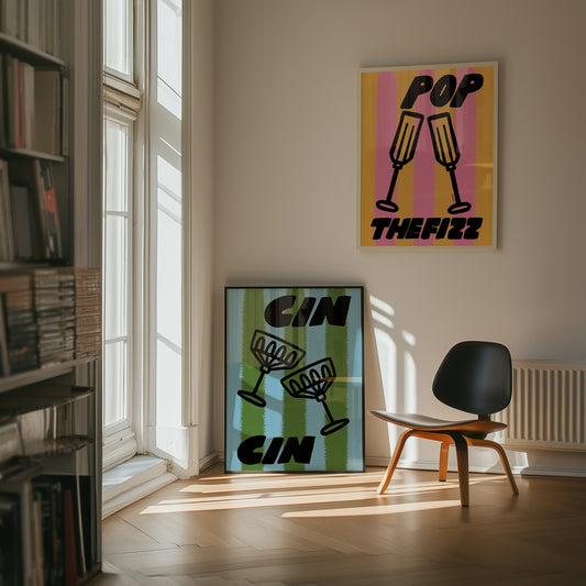 Modern interior with 'Pop The Fizz' and 'cin cin' posters on a wall.
