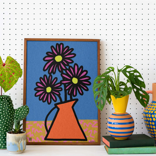 Aster birth flower print for September birthdays. Comes with a poem honouring wisdom, elegance, and heartfelt love. Decorative setup with a framed floral artwork, colourful vases, and plants on a white pegboard background.